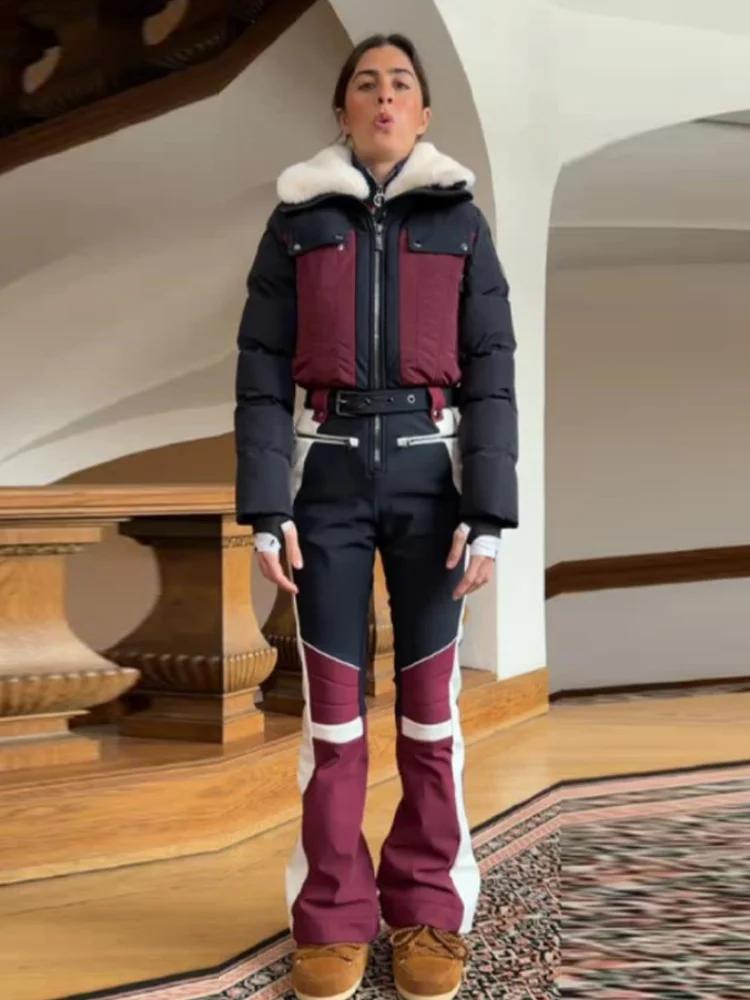 Combinaison de ski chic à blocs de couleur avec fermeture éclair et ceinture, manches longues, panta