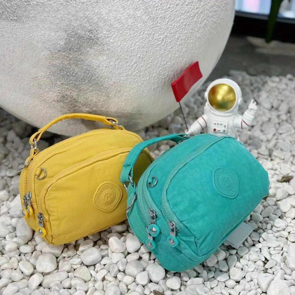 Sac à bandoulière en nylon multi-poches pour femme, sac à main à la mode avec bandoulière amovible.